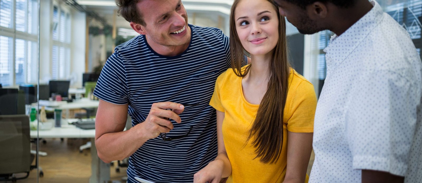 Male and female graphic designers interacting with each other in office